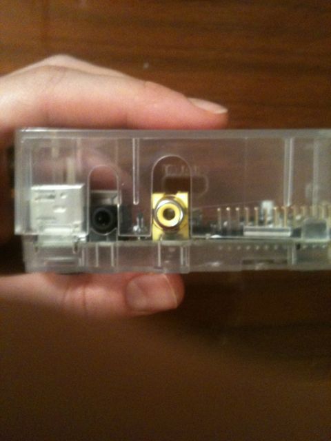 Placing the top part of the enclosure on our raspberry pi.